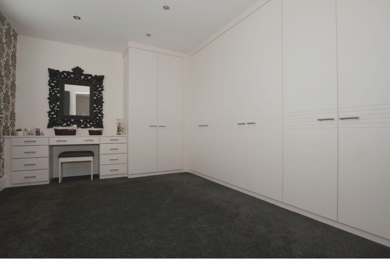 bedroom with bespoke wardrobes and vanity unit in white finish