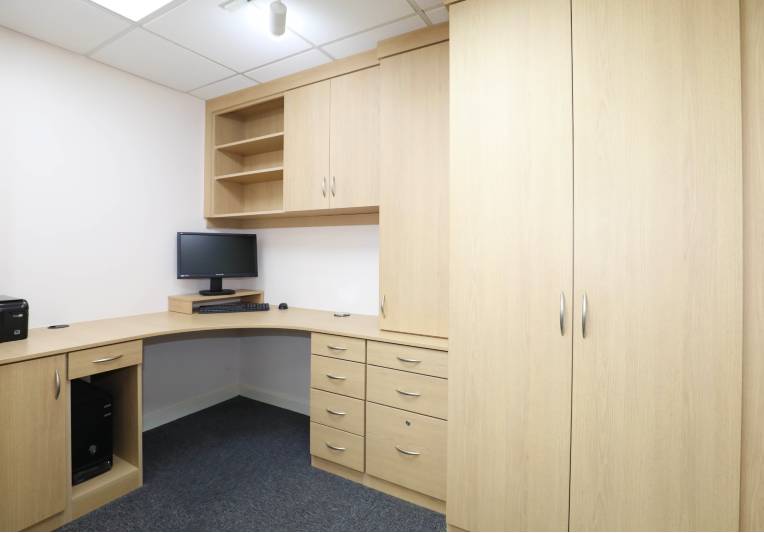 home office with bespoke fitted storage cupboards and desk in light pine colour